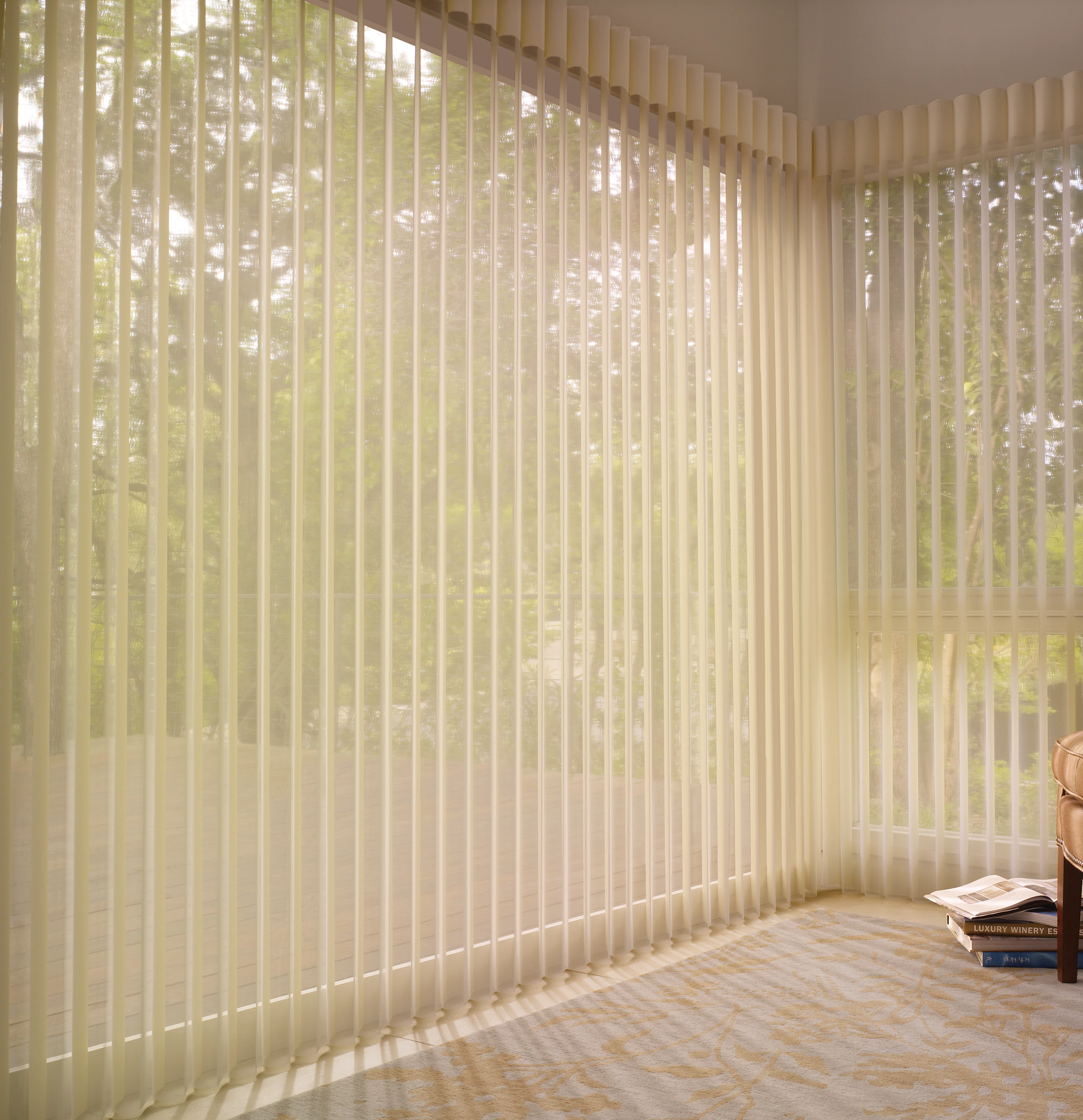 A living room with vertical blinds on the windows and a chair.
