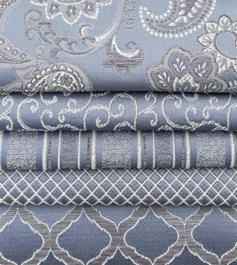 A stack of blue and white fabrics with a pattern on them.