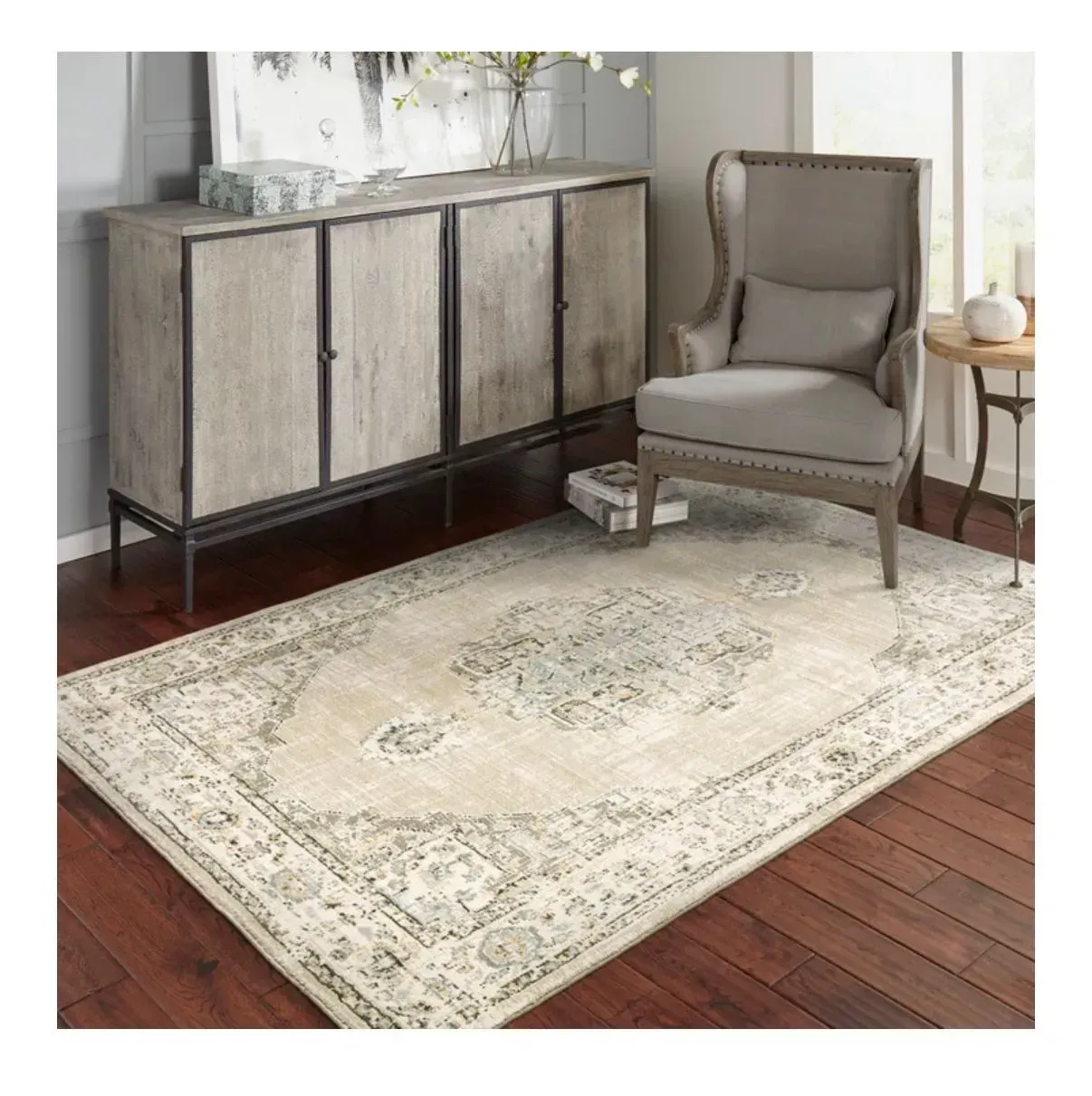 A living room with a rug , chair and dresser.