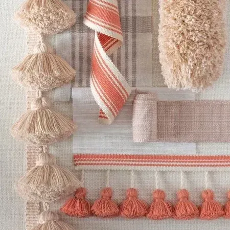 There are many different types of ribbons and tassels on the table.