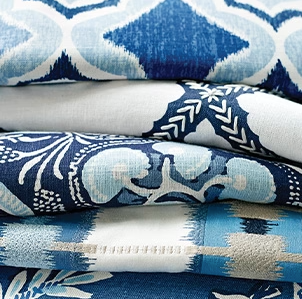 A close up of a stack of blue and white fabrics