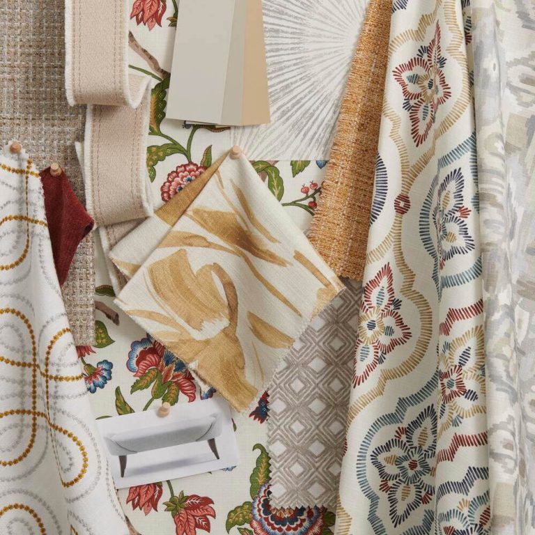 A bunch of fabrics are hanging on a wall