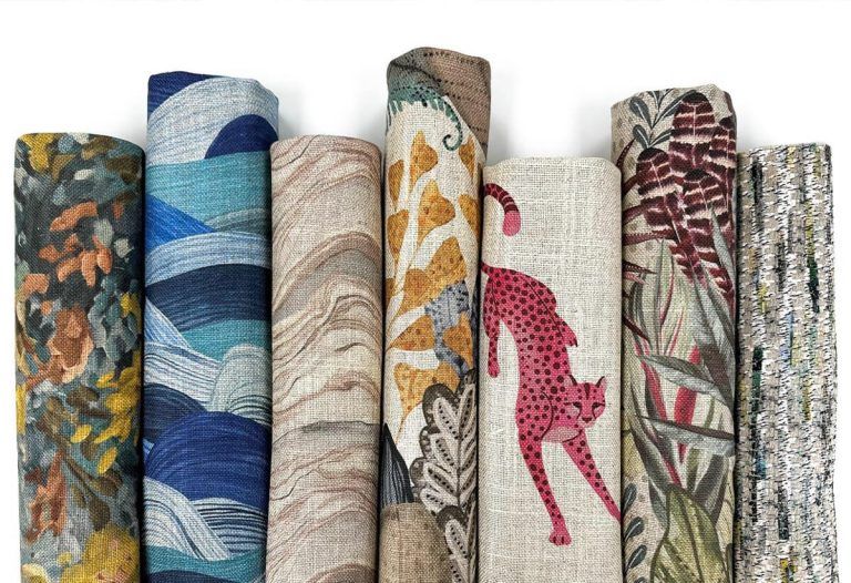 A row of rolls of fabric with different patterns on them.