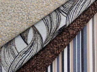 There are many different types of fabrics stacked on top of each other.