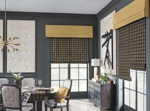 A dining room with a table and chairs and roman shades on the windows.