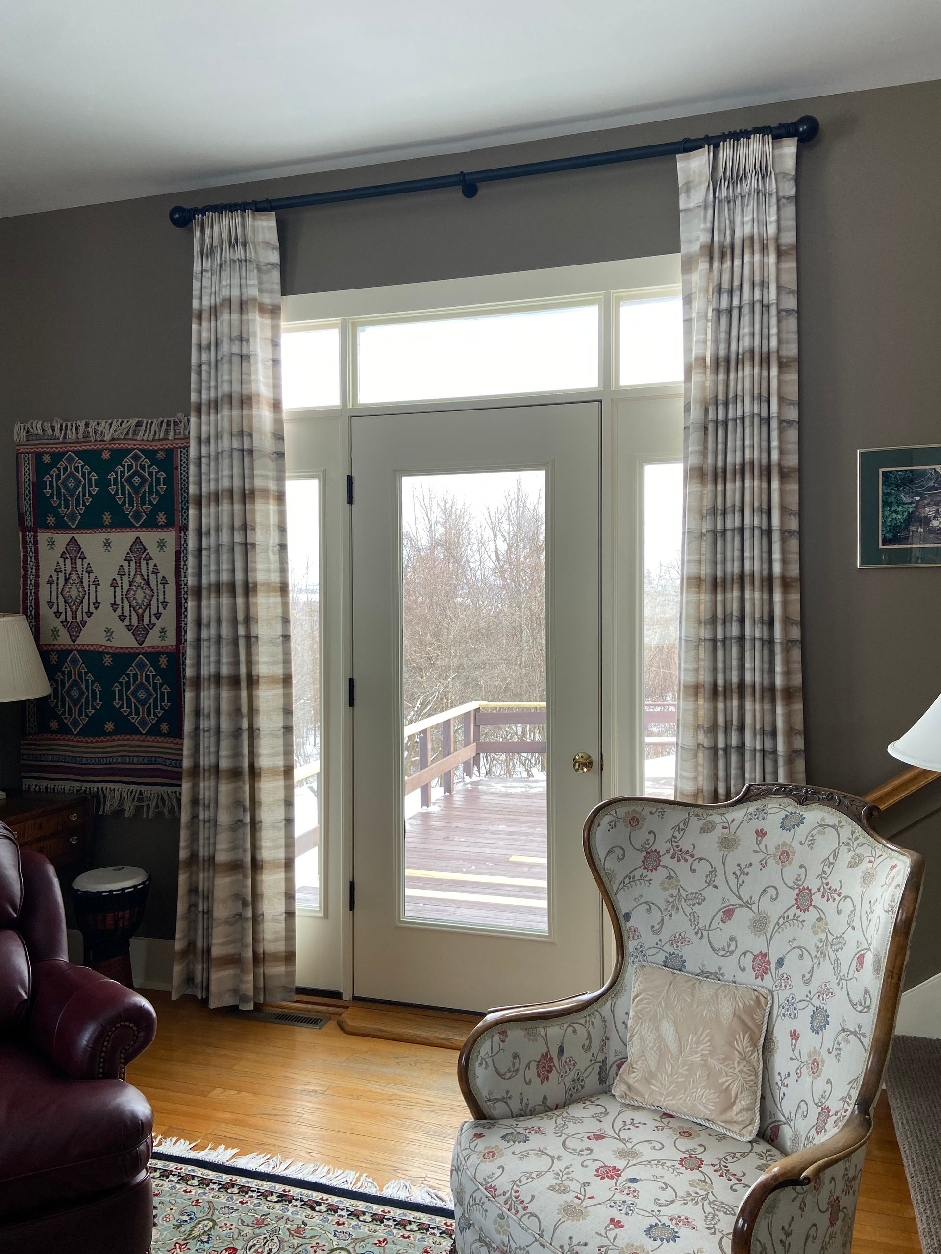A living room with a chair and a red leather chair