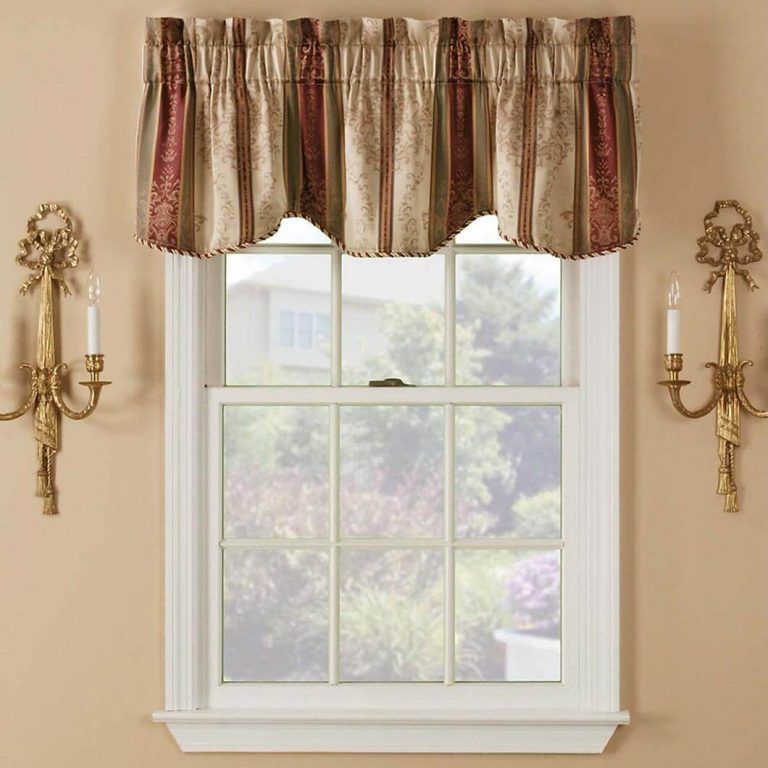 A window with a valance and candles on the wall