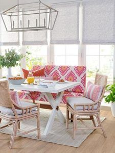 A dining room with a table , chairs , and a bench.