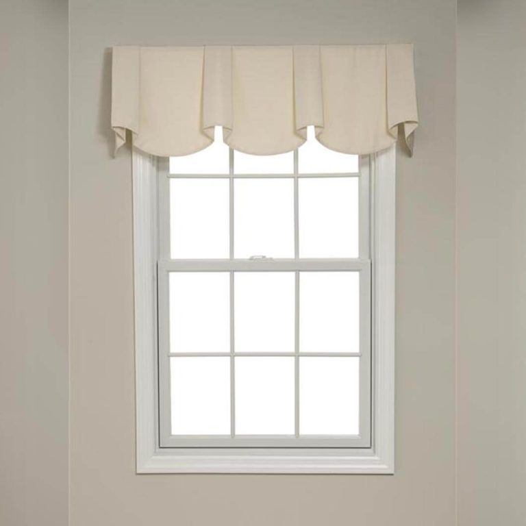 A window with a white valance on it in a room.