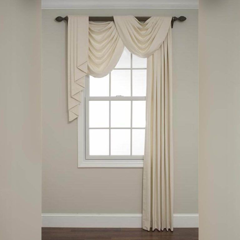 A white curtain is hanging on a window in a room.
