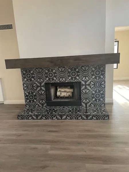 A fireplace with a stack of logs in it in a living room.