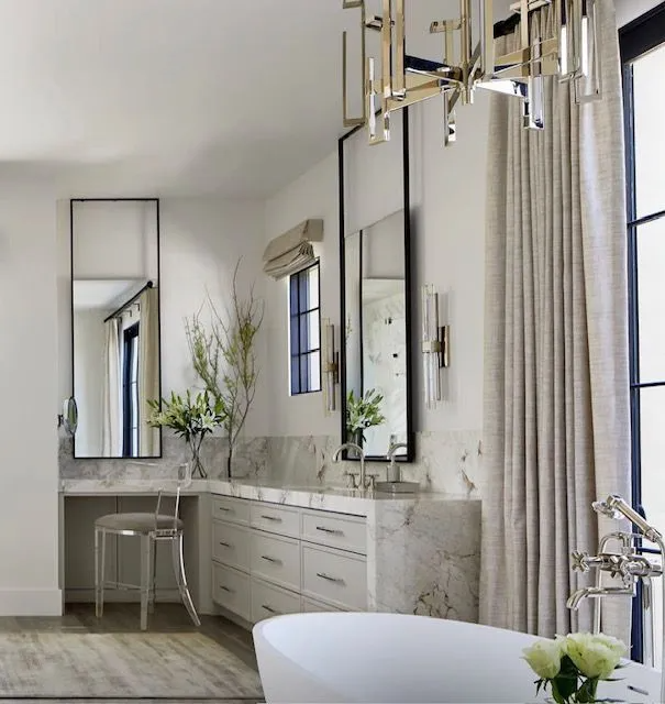 A bathroom with a bathtub and a mirror