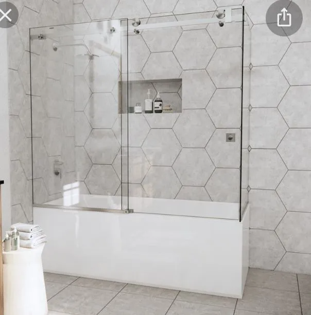 A bathroom with a bathtub and a glass shower door