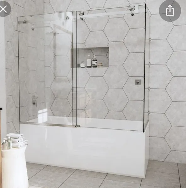 A bathroom with a sliding glass shower door