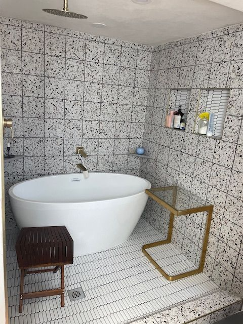 A bathroom with a bathtub and a shower.