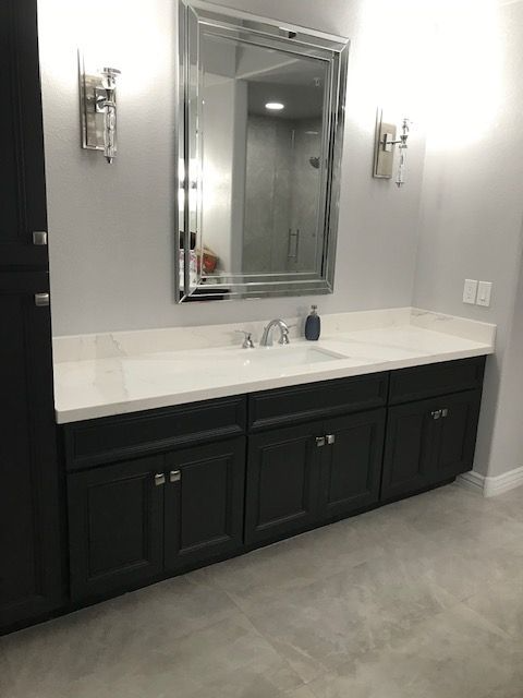 A bathroom with two sinks and a large mirror.