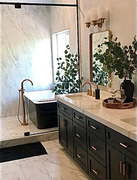 A bathroom with a tub , sink , and mirror