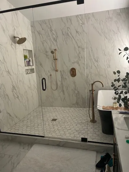 A bathroom with a walk in shower and a bathtub.