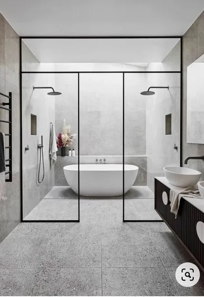 A bathroom with a bathtub , sink , and shower.