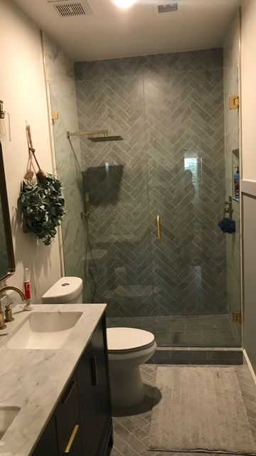 A bathroom with a toilet , sink , and walk in shower.