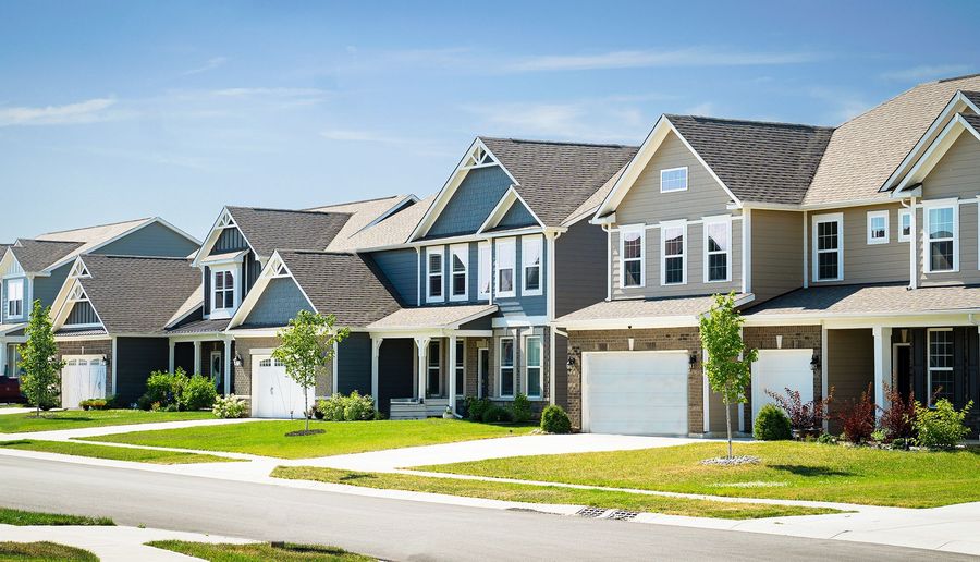 A row of houses on a sunny day in a residential neighborhood