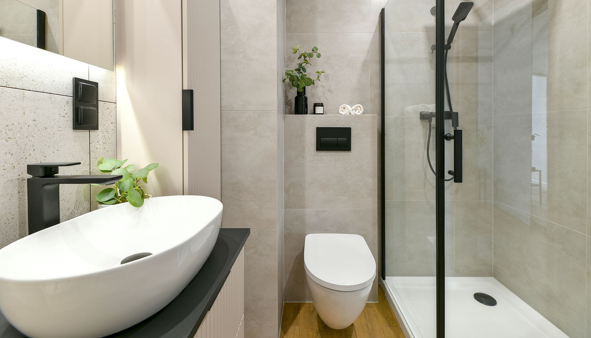 A bathroom with a sink , toilet and shower.