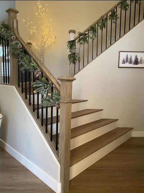 A staircase with a picture of trees on the wall