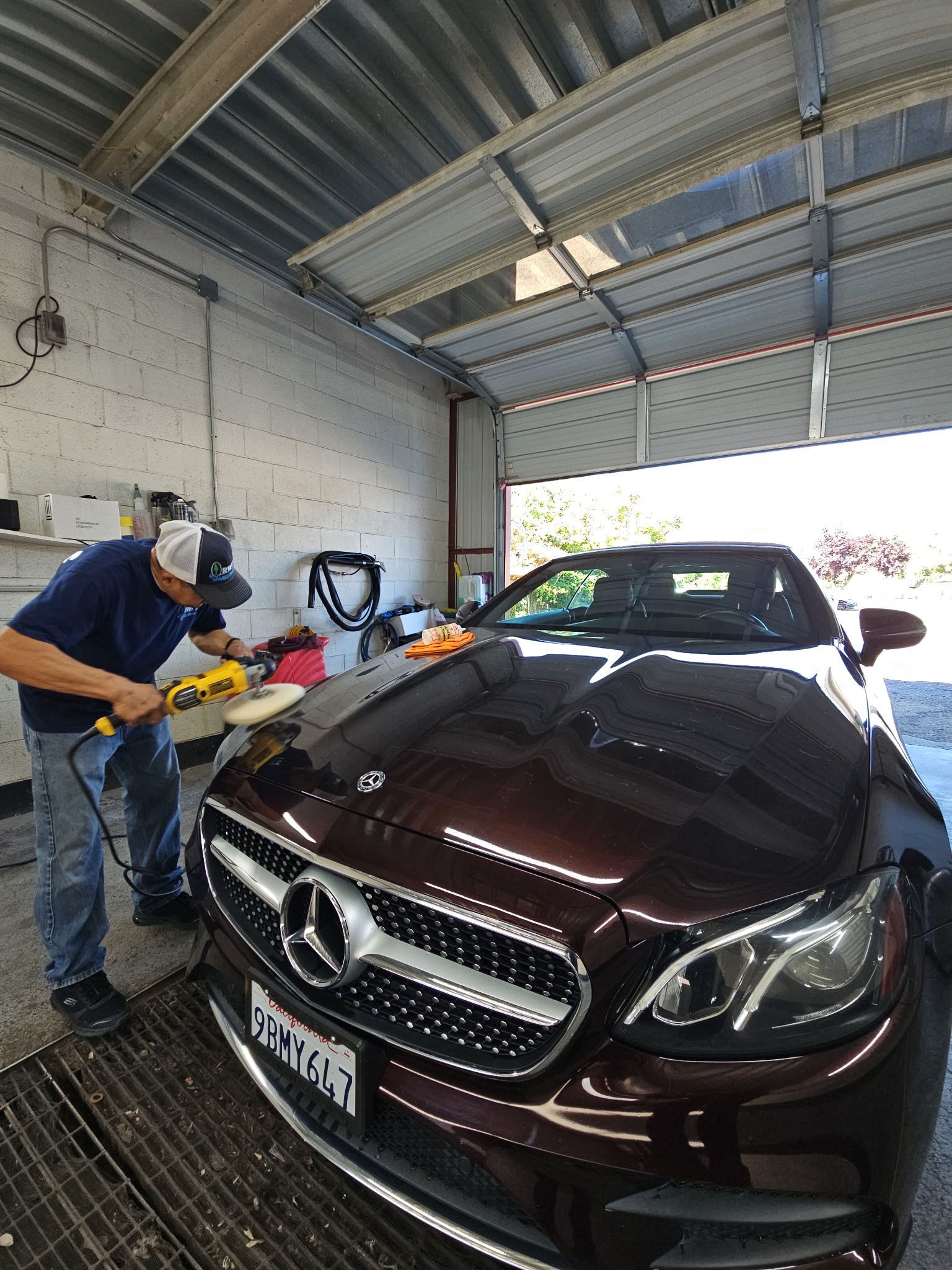 A mechanic is working on the brake disc of a car.