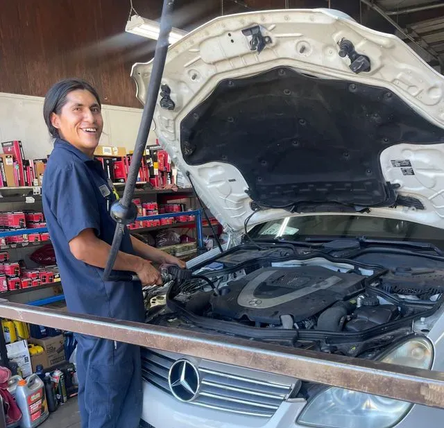A person is checking the oil level of a car engine
