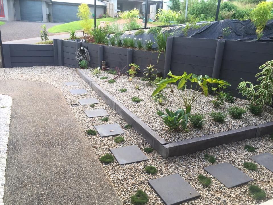 Landscaped Garden Bed With Dark Grey Retaining Wall — NQ Prefab Concrete Products Pty Ltd in Coconuts, QLD