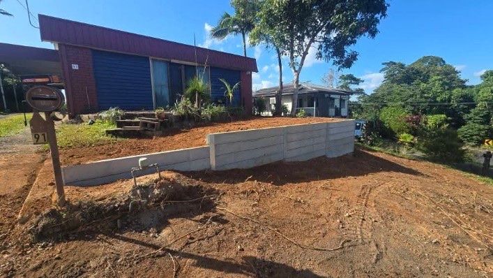Before and After Images of a Garden Bed Against a White Building — NQ Prefab Concrete Products Pty Ltd in Coconuts, QLD