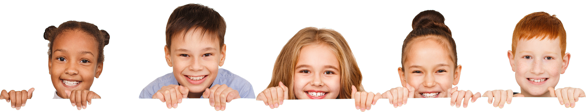 A group of children are peeking over a sign and smiling.