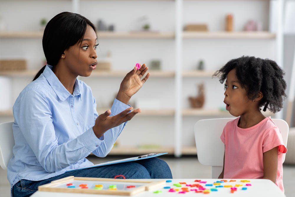 A Woman Is Teaching A Little Girl