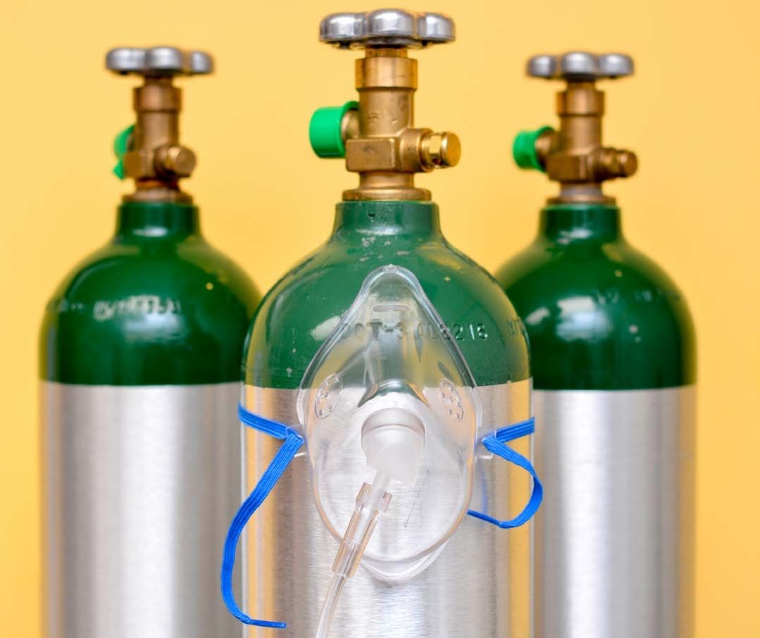 A close up of a bunch of yellow pipes with gauges on them.