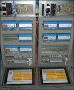 A couple of electrical panels with two monitors on them.