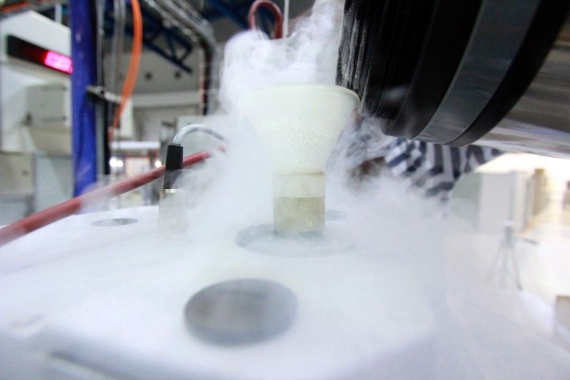 A close up of a container filled with liquid and smoke coming out of it.