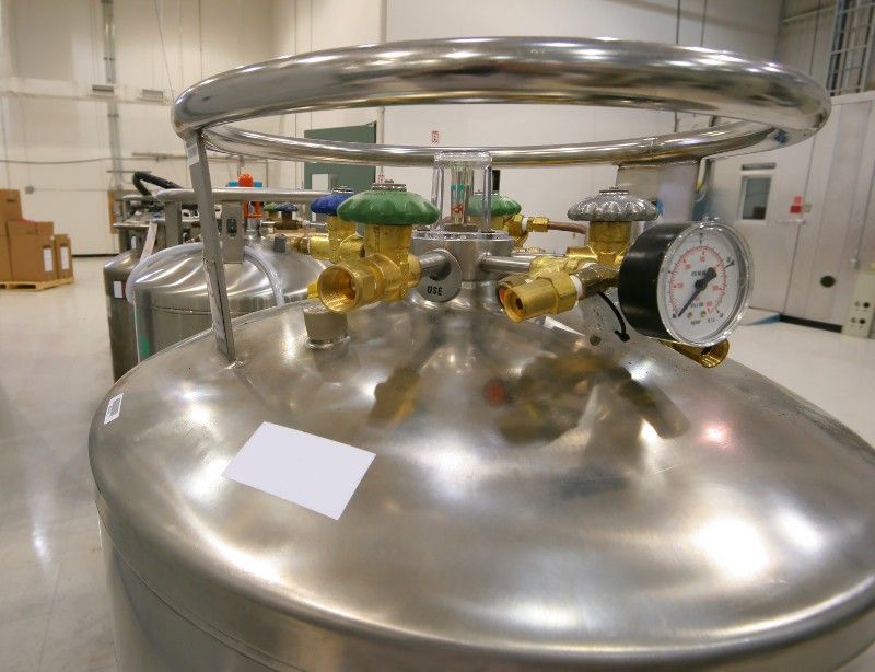 A stainless steel tank with valves and gauges on it