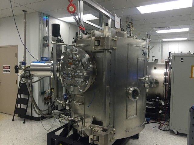 A large stainless steel machine is sitting in a room