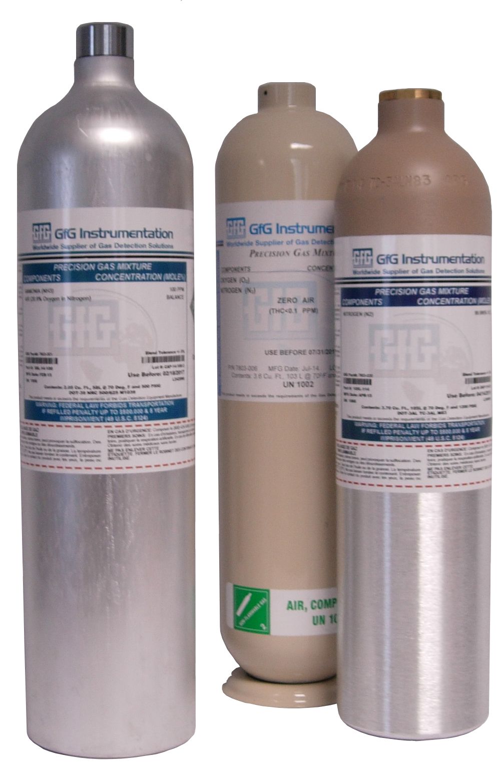 Three bottles of gas are sitting next to each other on a table.
