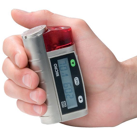A hand holding a device that says micro on it