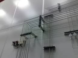 A bunch of pipes are hanging on a wall in a room.