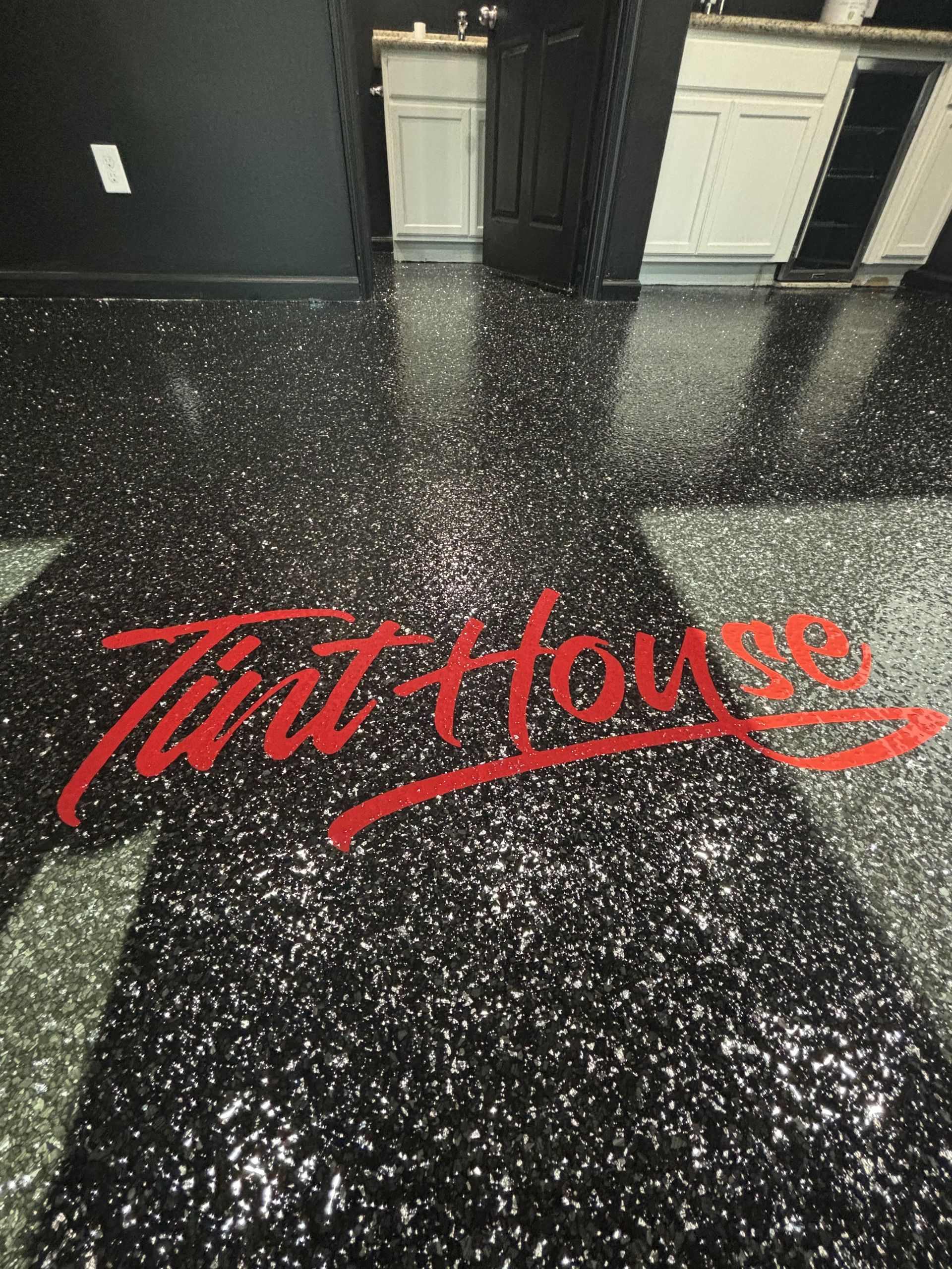 Black epoxy floor with embedded glitter and red