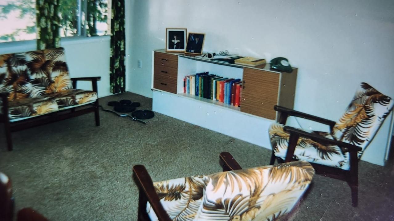 A living room with two chairs and a bookshelf