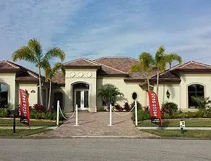 A large house with a lot of palm trees in front of it is for sale.