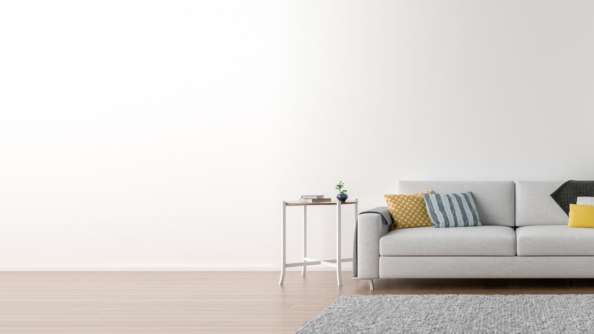 divano grigio chiaro con tavolino da caffè accanto