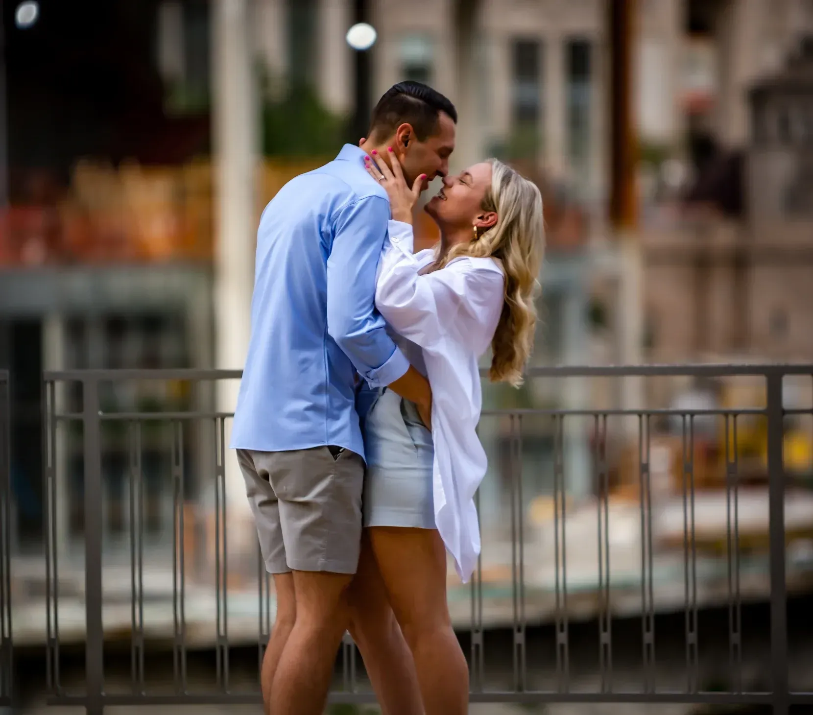 couple kissing on a bridge portrait