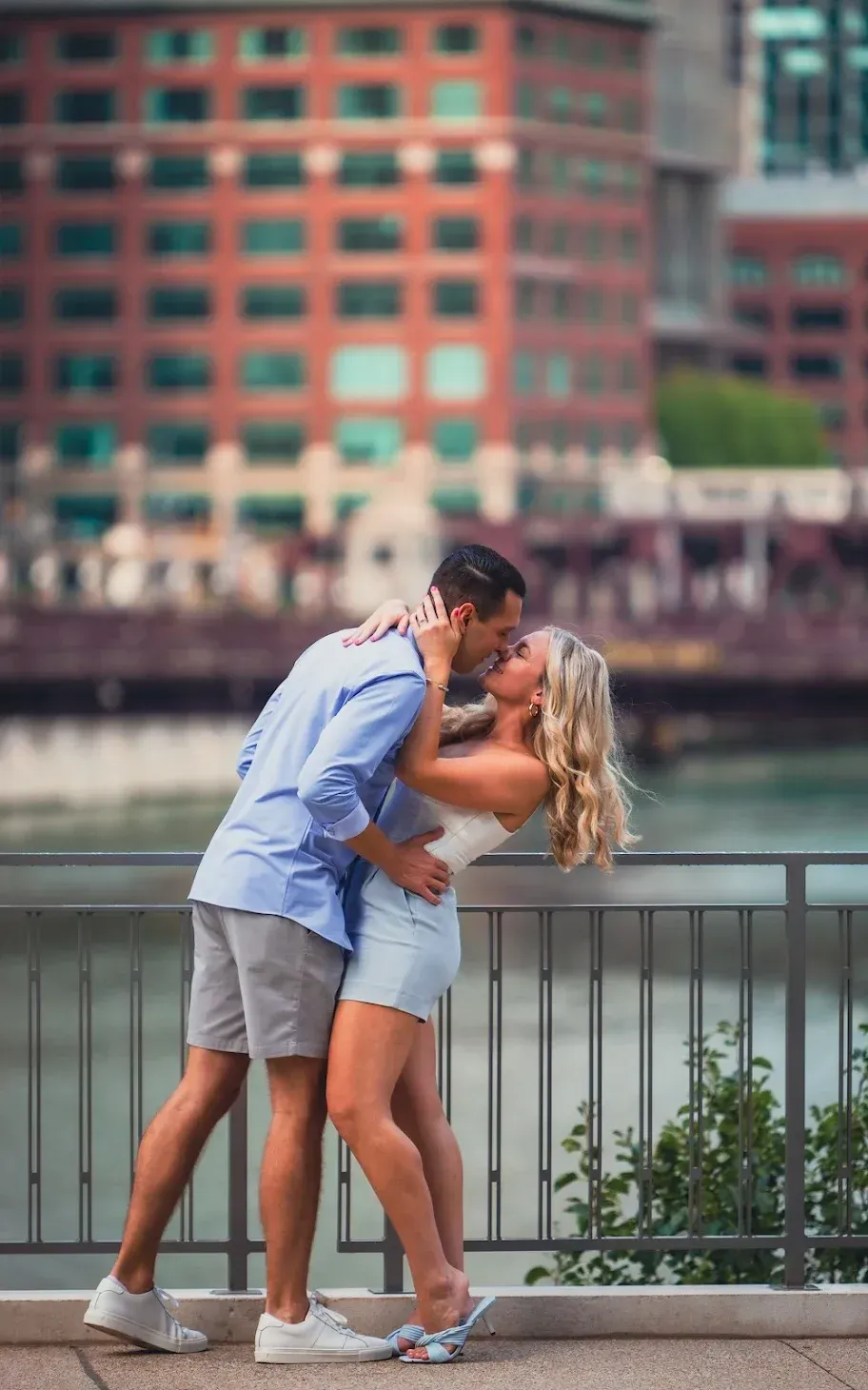 sweet couple kissing by a railing