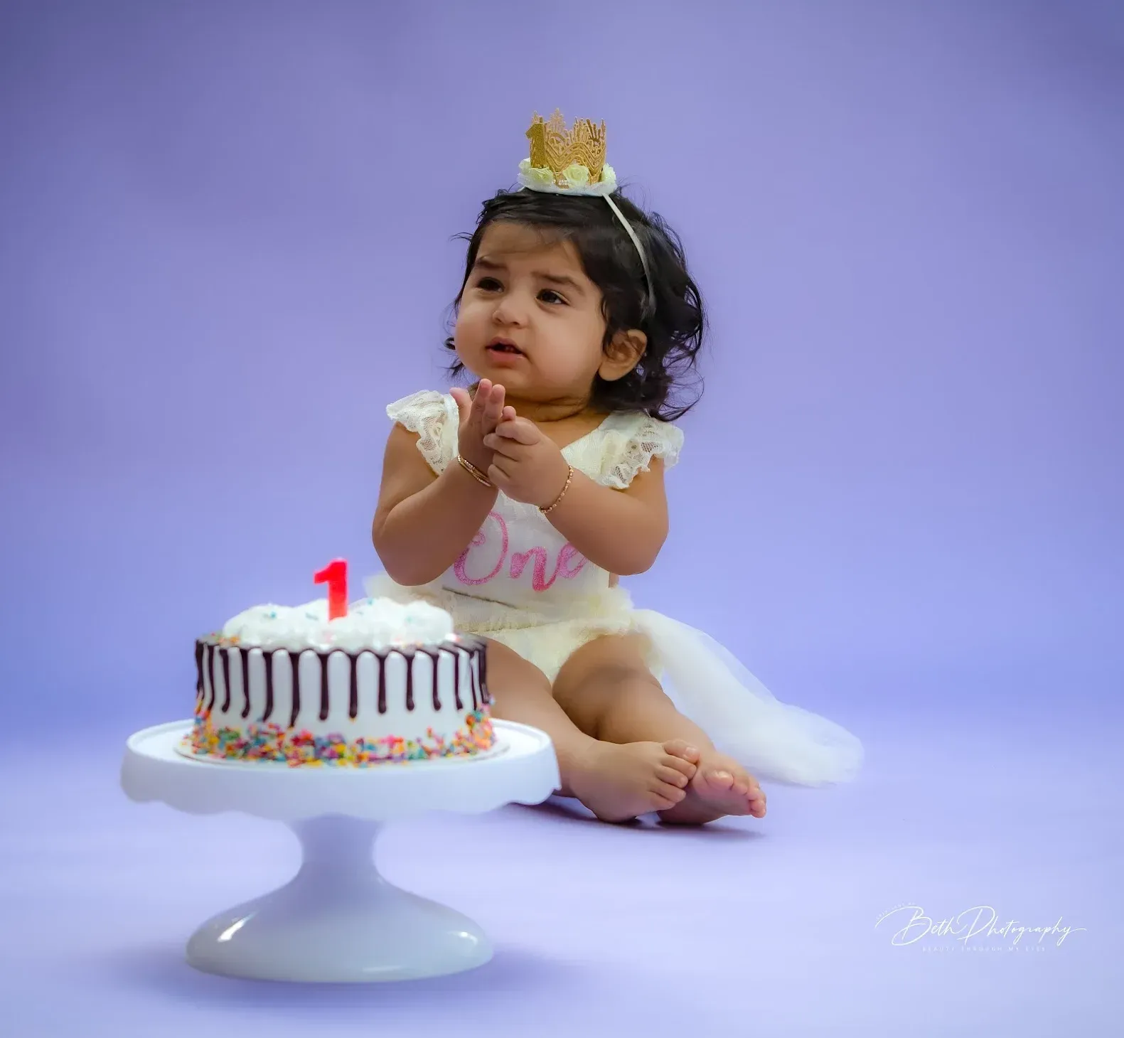 baby in a crown with studio background
