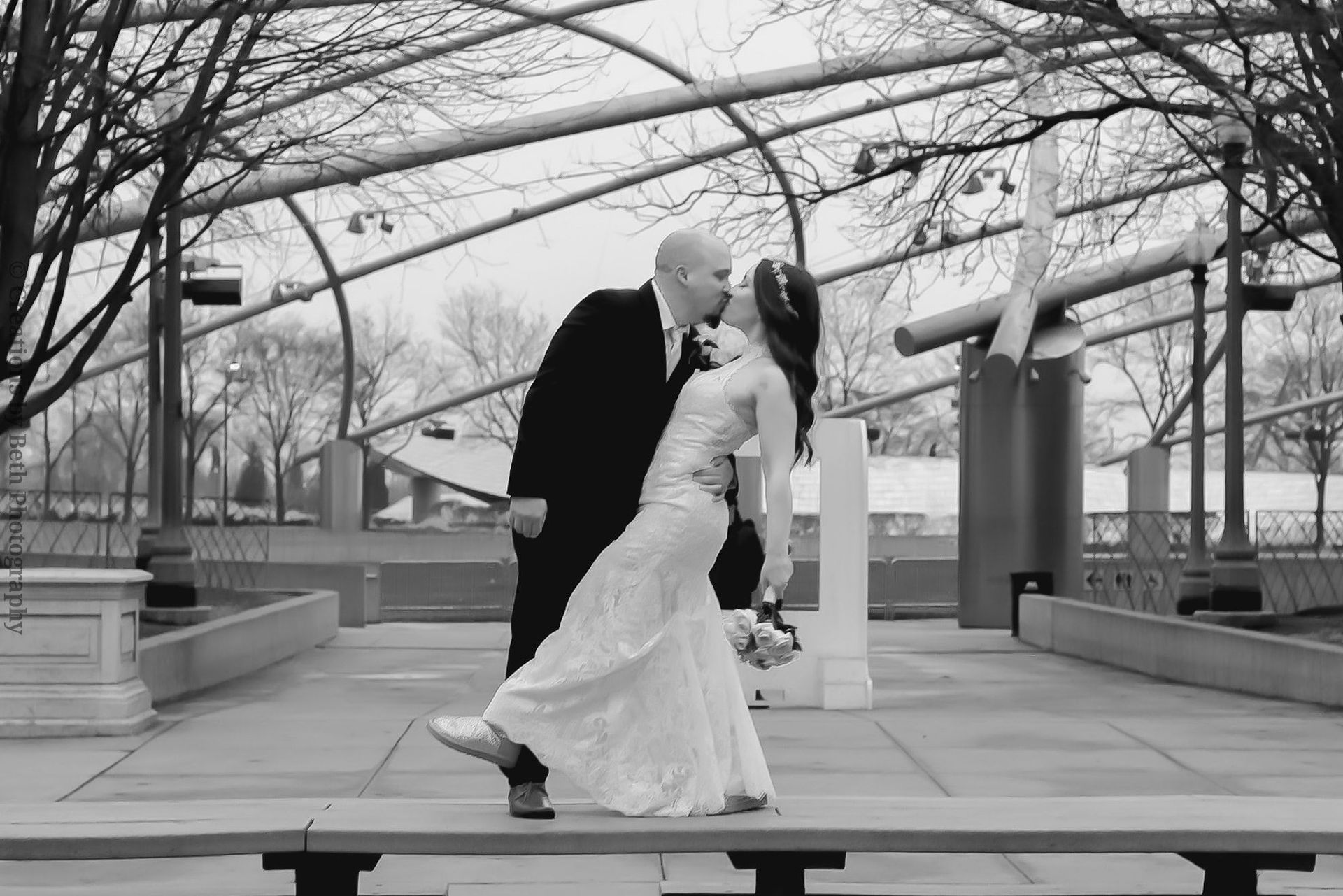 A bride and groom romantic kiss black and white portrait