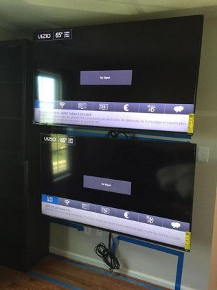 Two Vizio TVs mounted on a wall; both show a 